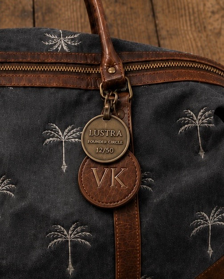 First Fifty antique brass badge, numbered and suspended from the bag